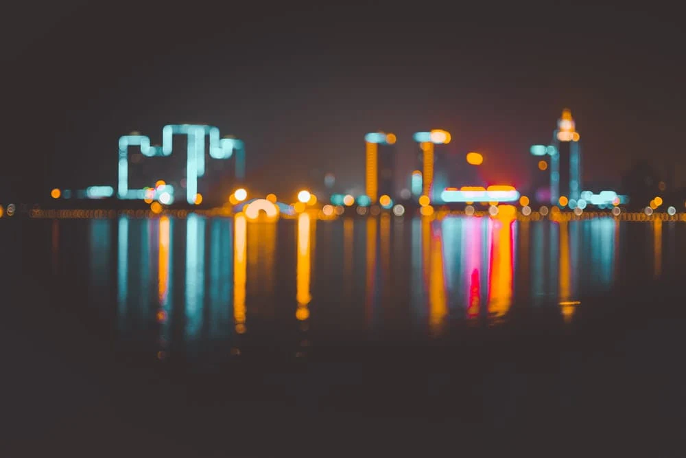 Paint By Numbers | Yulin - Bokeh Photography Of Cityscape On Body Of Water