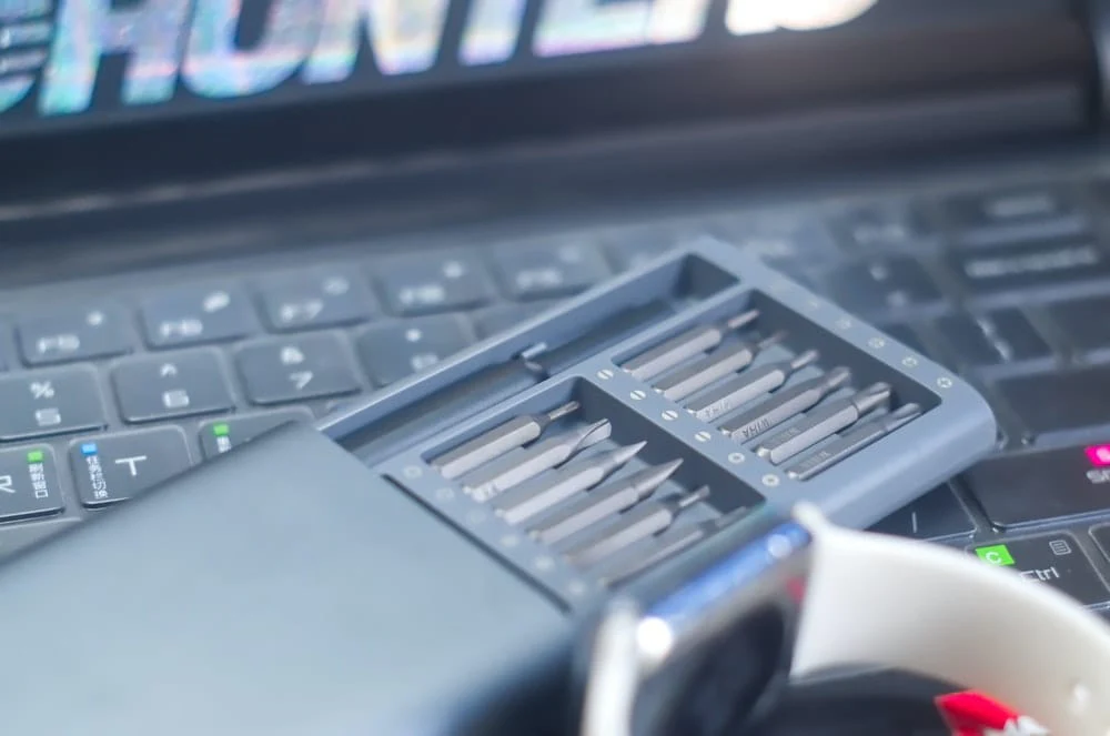 Paint By Numbers | Zhengzhou - Gray Screwdriver Set In Case On Top Of Black Computer Keyboard