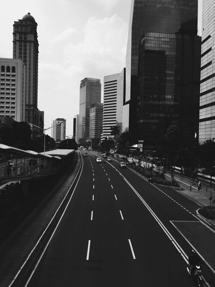 Paint By Numbers | Jakarta - Grayscale Photo Of Vehicle Running On Road Under Buildings
