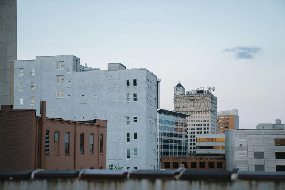 Paint By Numbers | Landscape Photography Of White And Brown Concrete Buildings Under Cloudy Sky