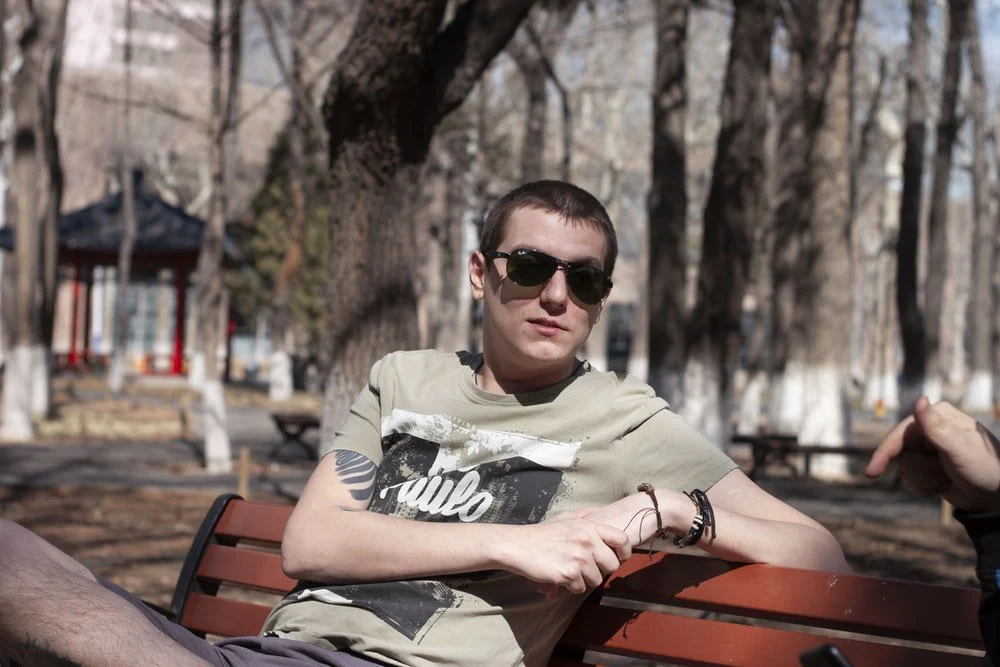 Paint By Numbers | Chaoyang - Man In Black Sunglasses And Gray And Black Long Sleeve Shirt Sitting On Brown Wooden Bench