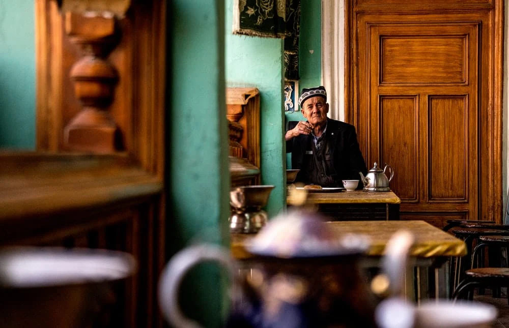 Paint By Numbers | Ürümqi - Man Sitting In Front Of Table Near Door