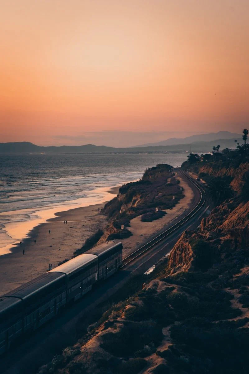 Paint By Numbers | San Diego - White And Black Train On Rail Near Body Of Water During Sunset