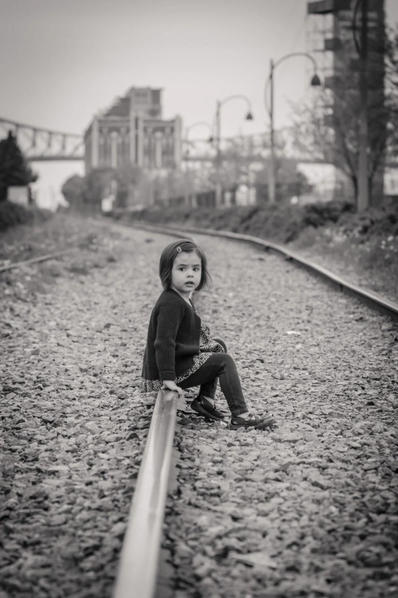 Paint By Numbers | Montréal - Woman In Black Jacket Sitting On Train Rail During Daytime