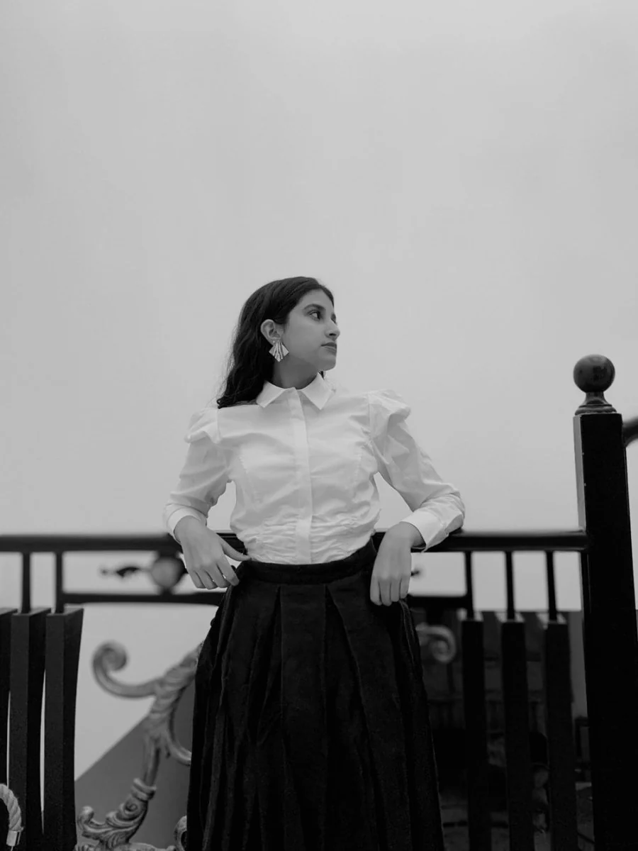 Paint By Numbers | Riyadh - Woman In White Dress Shirt And Black Skirt Standing Beside Black Wooden Chair