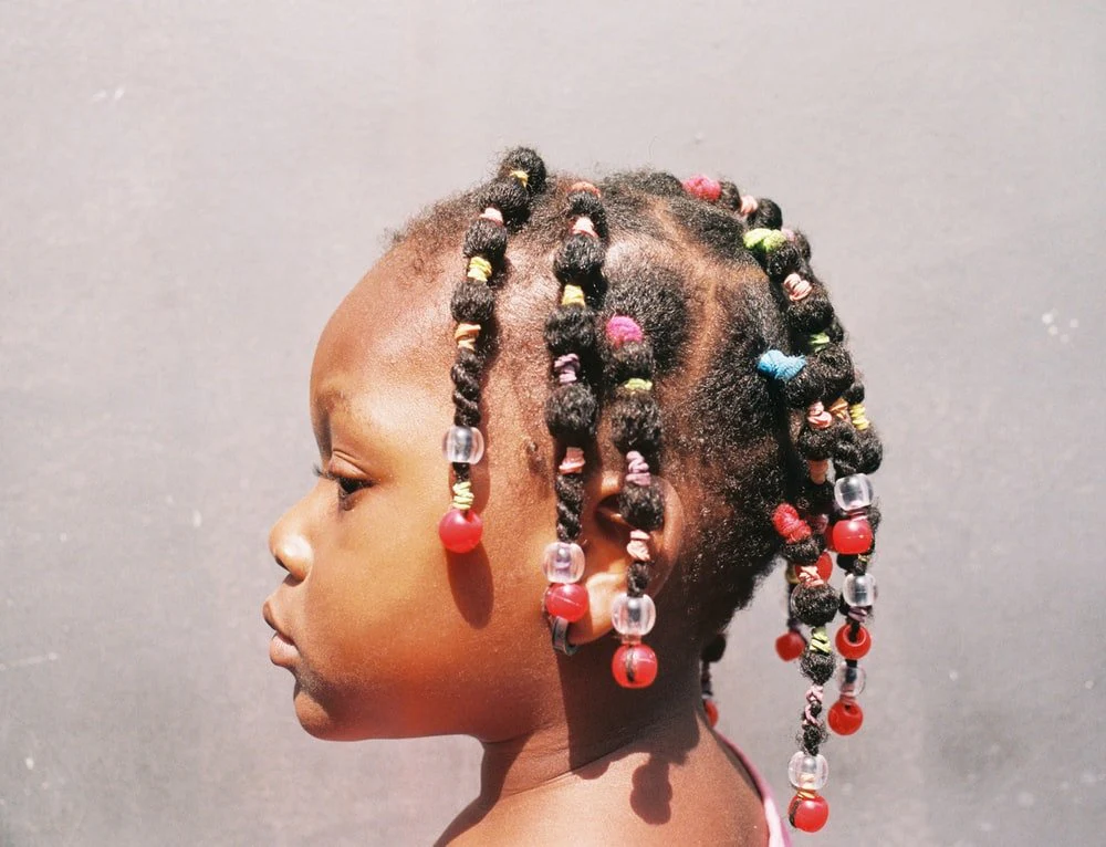 Paint By Numbers | Abidjan - Woman With Black And White Hair Tied With Silver And Red Earrings